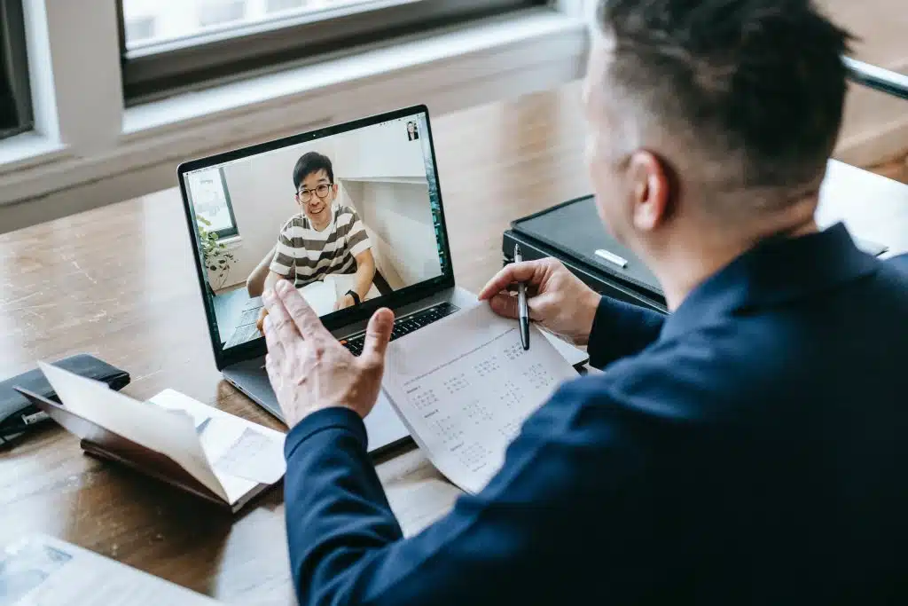 Professional online coaching session with mentor and student conducting virtual training via laptop